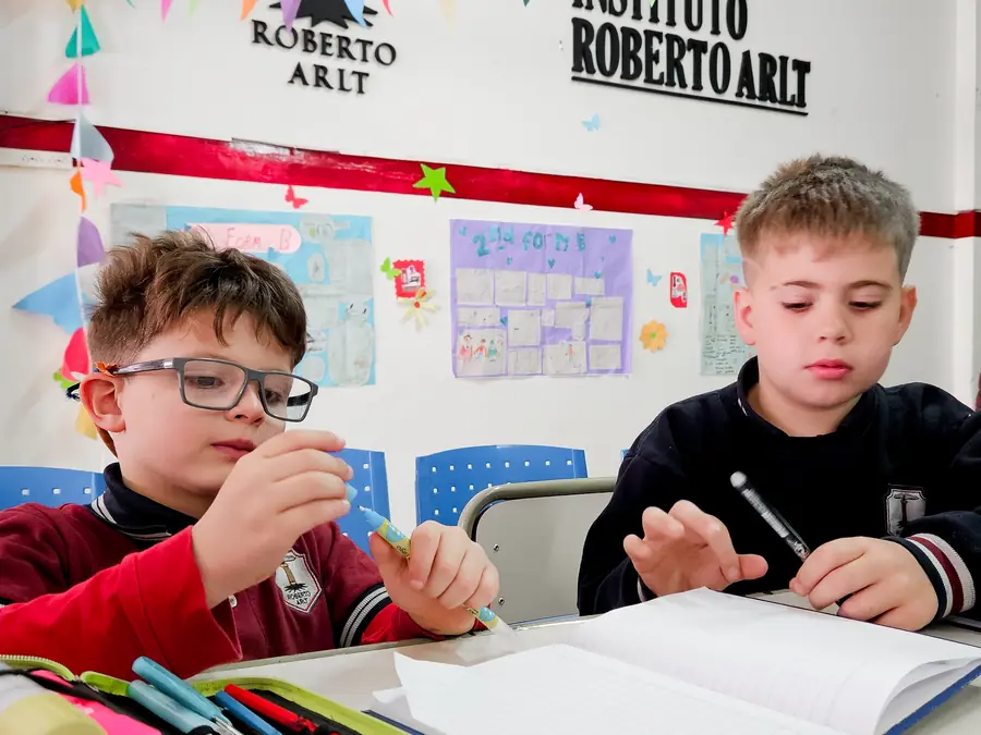 Alumnos escribiendo en el aula